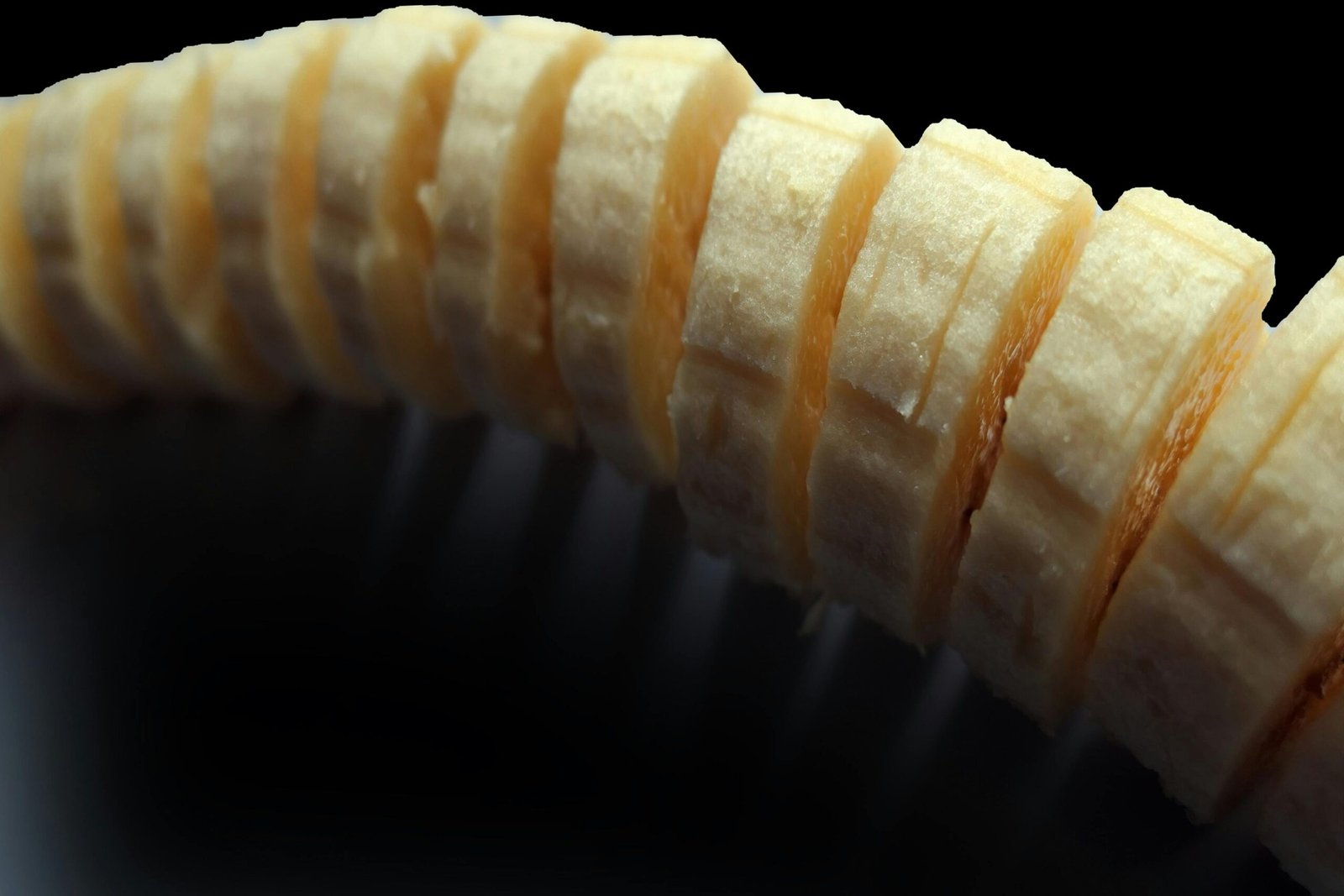 A detailed macro shot of fresh banana slices, showcasing their texture and natural freshness.