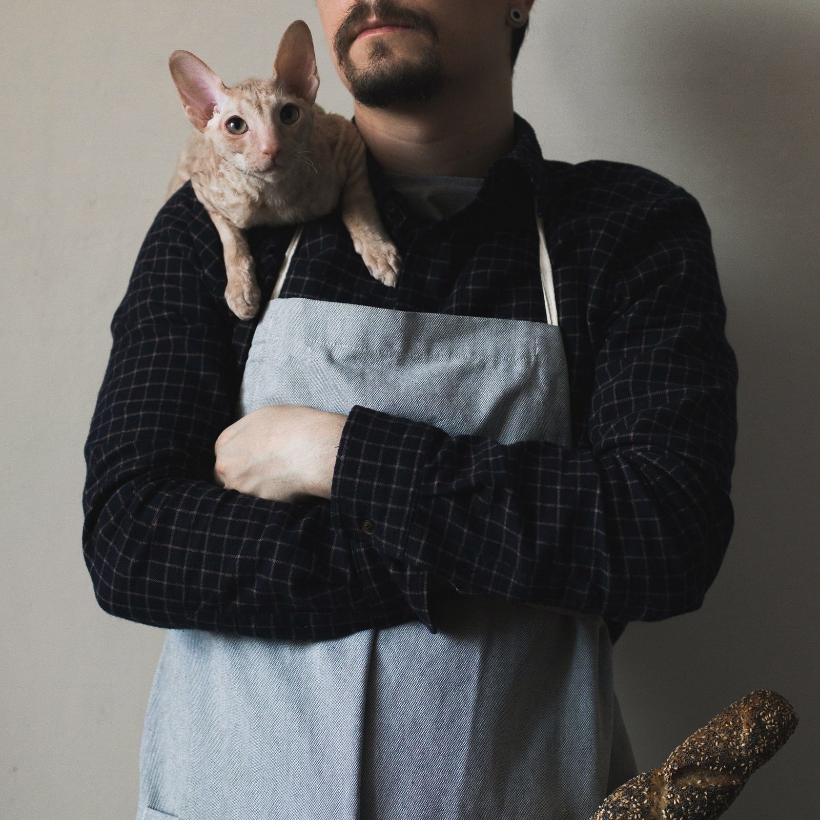 Man with cat in the kitchen ,cooking at home with pet