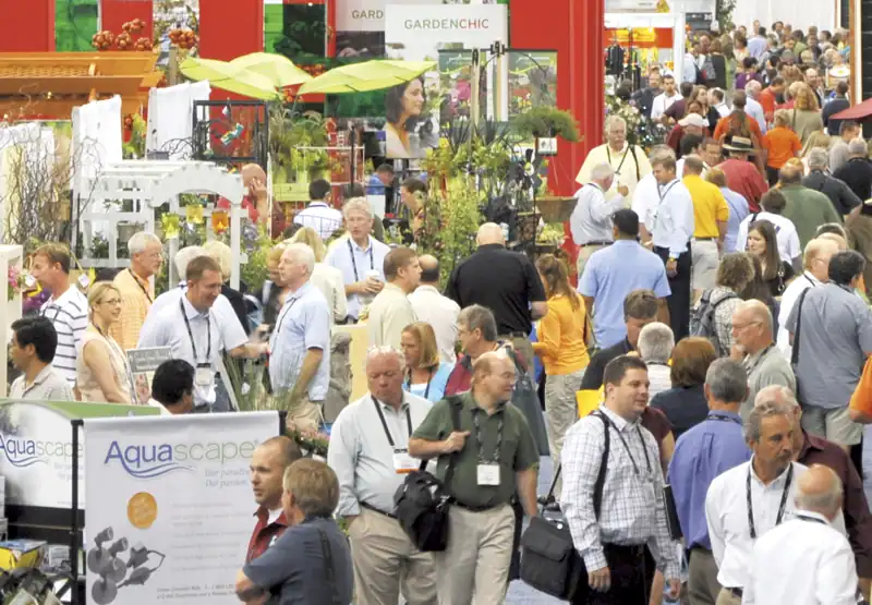Trade show floor with booths and attendees, similar to an exhibition-hall layout